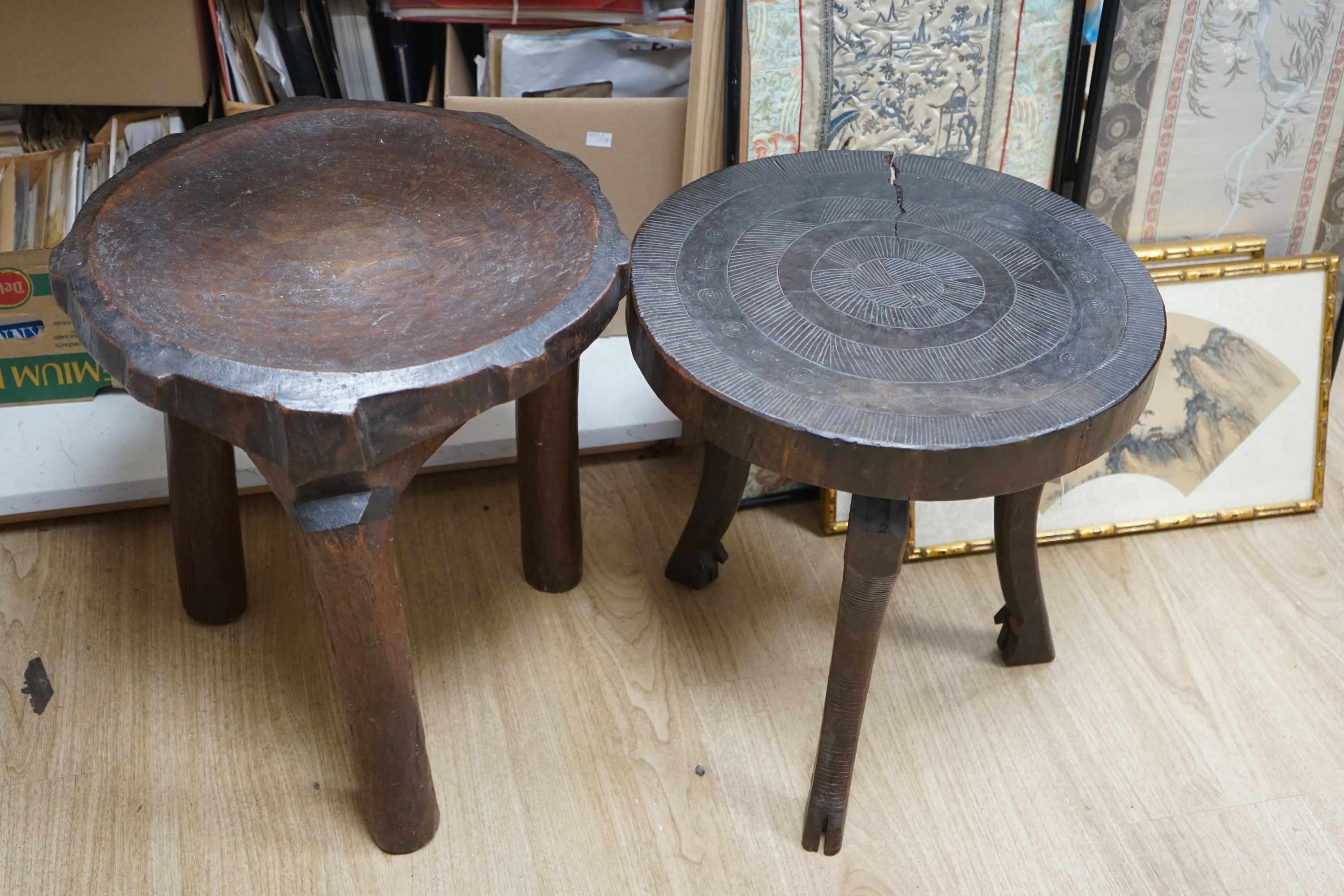 Two African circular carved hardwood low tables, larger 46cm diameter, height 50cm